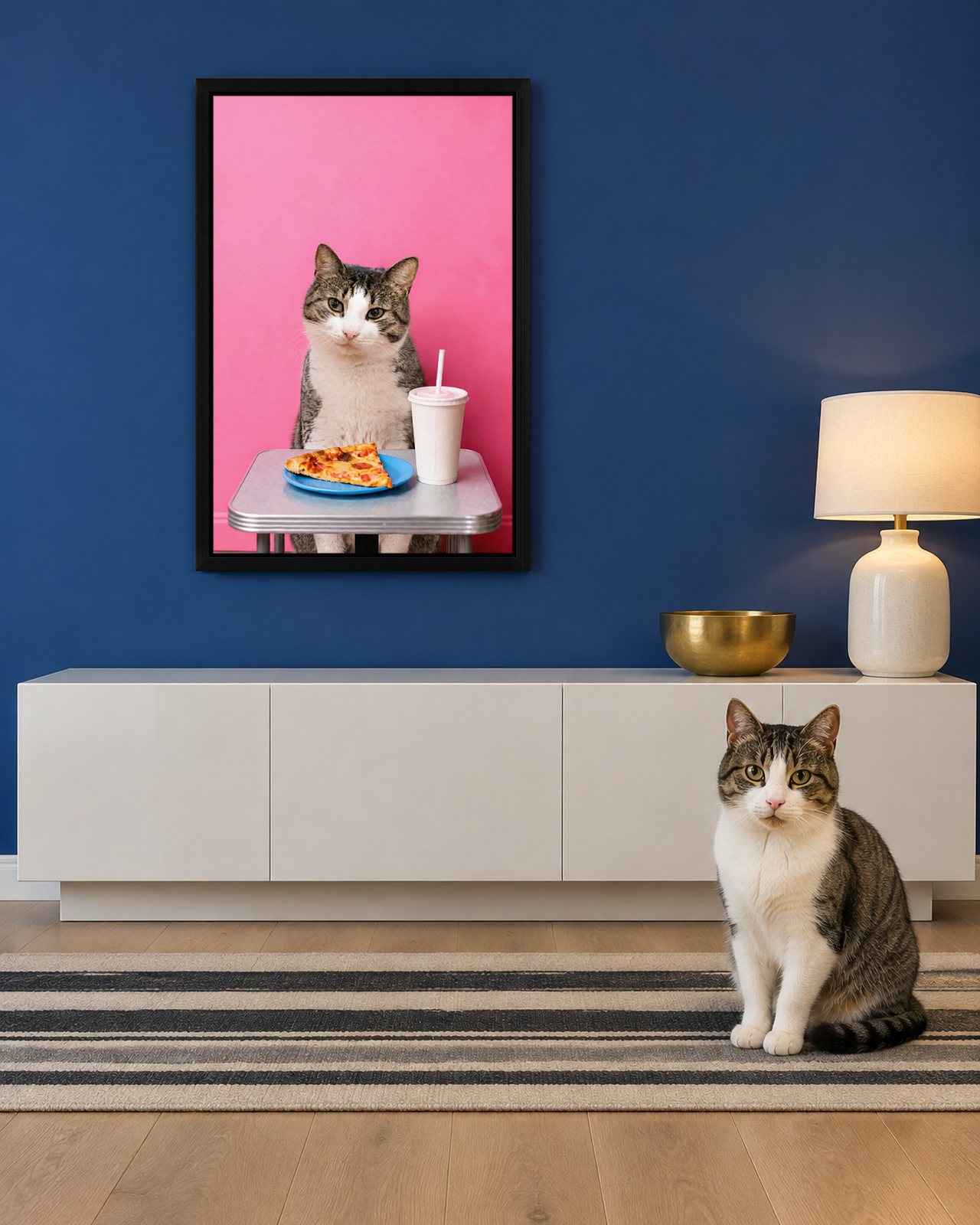 Pizza Night portrait on canvas in a black floating frame in a cobalt-blue entrance hall, with the cat beside it