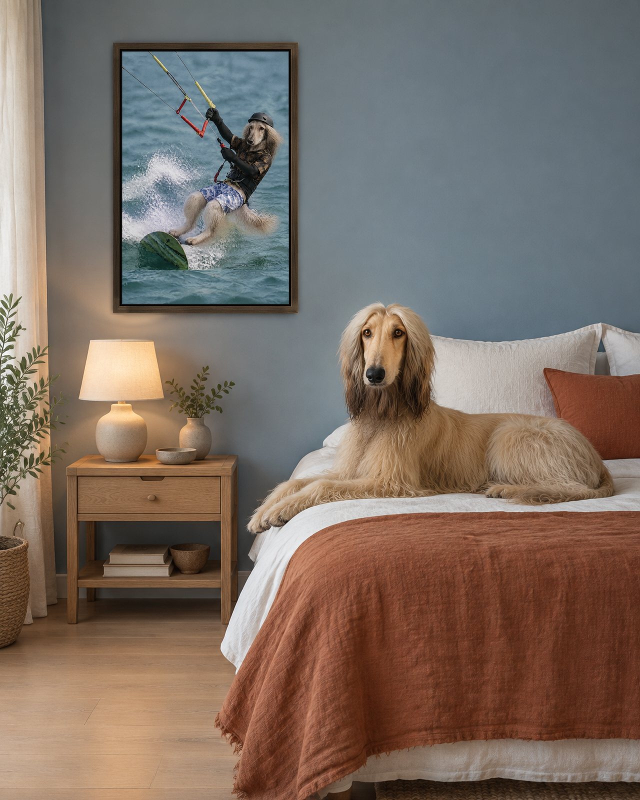 Kitesurfer portrait on canvas in a brown floating frame in a dusty-blue bedroom, with the dog beside it